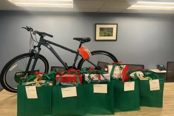 A restored bicycle displayed with gift bags prepared by RCAN supporters.